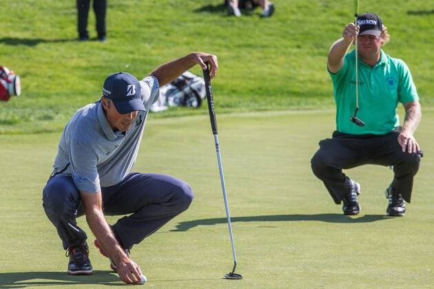 June 5, 2016 - Dublin, Ohio, U.S - Matt Kuchar places his ball while William McGirt lines up his putt in the background on the 18th green during the final round of The Memorial Tournament at Muirfield Village Golf Club, Dublin, Ohio. Golf 2016 - The Memorial Tournament - Final Round - ZUMAs304