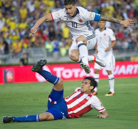 PASADENA, June 7, 2016 -- Colombia s James Rodriguez (Top) jumps over Paraguay s Gustavo Raul Gomez during the Copa America Centenario Group A match at Rose Bowl Stadium in Pasadena, California, the United States, June 7, 2016. ) (SP)U.S.-PASADENA-COPA AMERICA-GROUP A-COL VS PAR YangxLei 