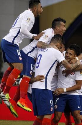 Chile players from left defender Gonzalo Jara (18), defender Gary Medal (17), forward Maurico Pinilla (9) and forward Alexis Sanchez (7) surround midfielder Arturo Vidal after Vidal scored in the second half of the Copa America Centenario Group D match against Bolivia at Gillette Stadium in Foxboro, Massachusetts on on June 10, 2016. Chile defeated Bolivia 2-1.  BOS2016061010 MATTHEWxHEALEY