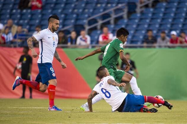 June 10, 2016 - Foxborough, Massachusetts, U.S - Chile midfielder ARTURO VIDAL (8) slides in on Bolivia defender DIEGO BEJARANO (4) while Chile forward MAURICIO PINILLA (9) looks on during the Copa America Centenario football tournament at Gillette Stadium in Foxborough, MA. Soccer 2016 - Copa America Centenario Uruguay vs. Venezuela - ZUMAs192