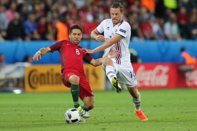 June 14, 2016 - St Etienne, France - Joao Moutinho (POR), Gylfi Sigurdsson (ISL), during the UEFA EURO EM Europameisterschaft Fussball 2016 Group F match between Portugal and Iceland at Stade Geoffroy-Guichard on June 14, 2016 in Saint-Etienne, France. Portugal v Iceland - Group F: UEFA Euro 2016  - ZUMAn230
