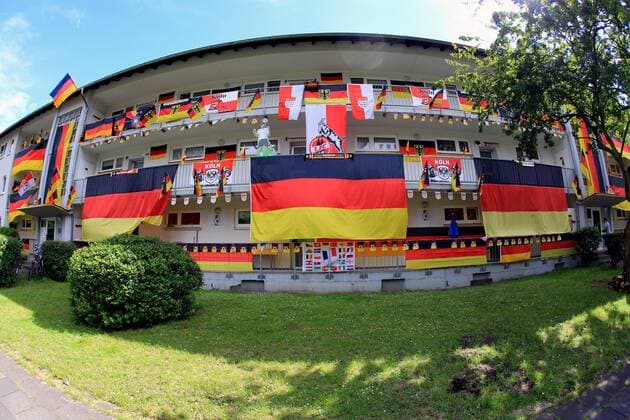 Deutschland-Fahnen hängen an anläßlich der Fußball-EM 2016 in Frankreich an einer Hausfassade in Köln. Fahnen zur Fußball-EM