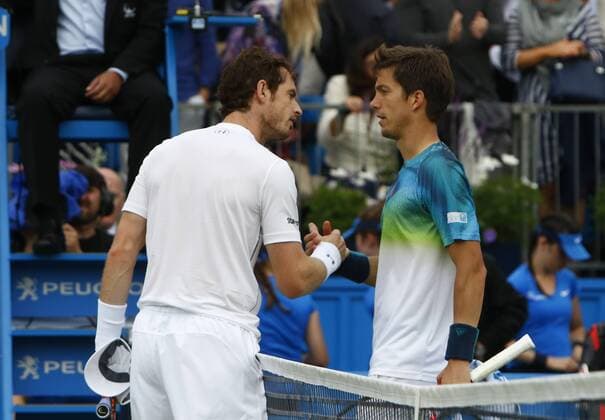 16.06.2016. Queens Club, London, England. Aegon Queens Tennis Championships Day Four. Reigning Queens singles champion Andy Murray consoles Aljaz Bedene (GBR) after their 2nd round match. Murray won in straight sets 6-3, 6-4. xAlanxMartinx  ActionPlus11749986