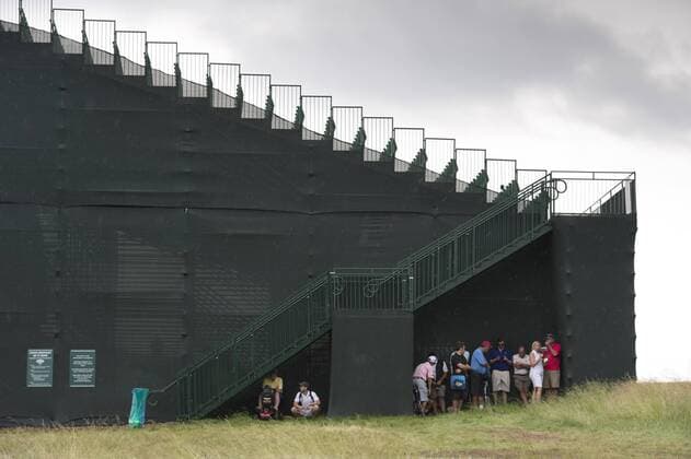Golf, US Open Patrons seek shelter under a grandstand during a rain delay in the first round of the 2016 U.S. Open at Oakmont Country Club in Oakmont, Pennsylvania on June 15, 2016.  OAK20160616306 KEVINxDIETSCH