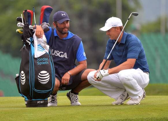 Jordan Spieth and his caddie Michael Greller talk on the 17th green during the first round of the 2016 U.S. Open at Oakmont Country Club in Oakmont, Pennsylvania on June 15, 2016.  OAK20160616322 KEVINxDIETSCH