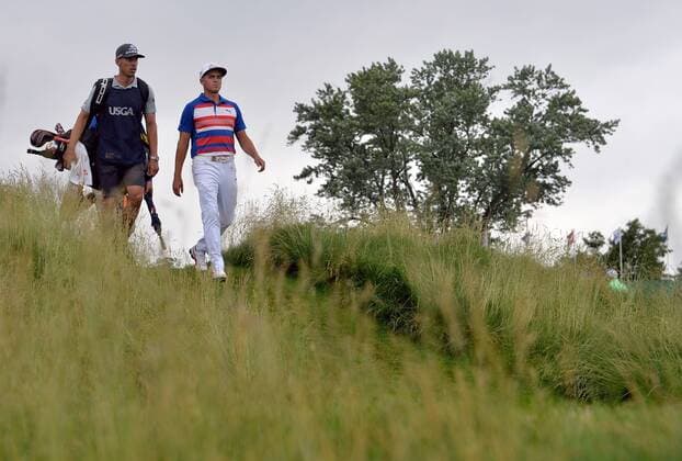 Rickie Fowler and his caddie Joe Skovron walk on the 12th fairway during the first round of the 2016 U.S. Open at Oakmont Country Club in Oakmont, Pennsylvania on June 16, 2016.  OAK20160616332 KEVINxDIETSCH