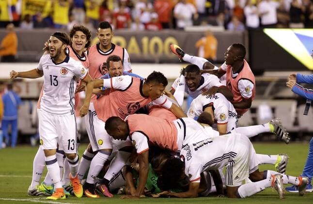 The Colombia team pile on goalie David Ospina after their victory over Peru at the Copa America Centenario USA 2016 quarter-finals at MetLife Stadium in East Rutherford, New Jersey on June 17, 2016. Colombia defeated Peru 0-0 and 4-2 on penalties.  NYP20160617149 JOHNxANGELILLO
