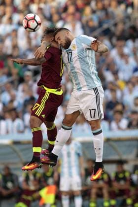 Argentina defender Nicholas Otamendi (17) and Venezuela forward Josef Martinez (17) jump up for a header in the first half of the 2016 Copa America Centenario quarterfinal match against Venezuela at Gillette Stadium in Foxborough, Massachusetts on June 18, 2016.  BOS2016061806 MATTHEWxHEALEY