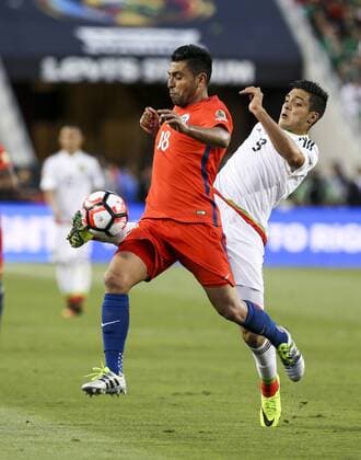 June 18, 2016 - Los Angeles, California, U.S - Chile defender Gonzalo Jara 18 vies the ball against Mexico forward Raul Jimenez 9 in the Copa America soccer match between Mexico and Chile at the LeviÃ s Stadium in Santa Clara, California, June 18, 2016. Chile won 7-0. Copa America 2016 Quarterfinal Chile defeats Mexico 7-0 - ZUMAc68_