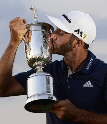 Dustin Johnson kisses the Championship Trophy on the 18th green after winning his first major championship in the final round at the U.S. Open at Oakmont Country Club near Pittsburgh, Pennsylvania on June 19, 2016. Johnson won with a score of 5 under par.  OAK20160619323 ARCHIExCARPENTER