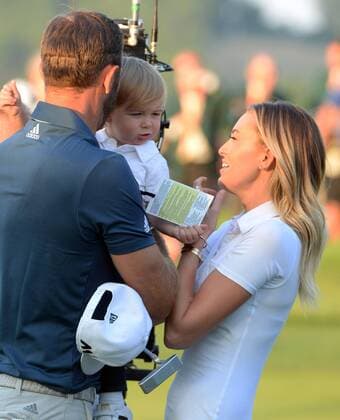 Dustin Johnson celebrates with Paulina Gretzky and son Tatum on the 18th green after making a birdie putt and winning his first major championship in the final round at the U.S. Open at Oakmont Country Club near Pittsburgh, Pennsylvania on June 19, 2016. Johnson won with a score of 5 under par.  OAK20160619874 PATxBENIC