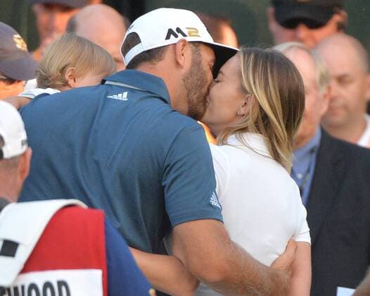 Dustin Johnson celebrates by kissing Paulina Gretzky on the 18th green after making a birdie putt and winning his first major championship in the final round at the U.S. Open at Oakmont Country Club near Pittsburgh, Pennsylvania on June 19, 2016. Johnson won with a score of 5 under par.  OAK20160619879 KEVINxDIETSCH