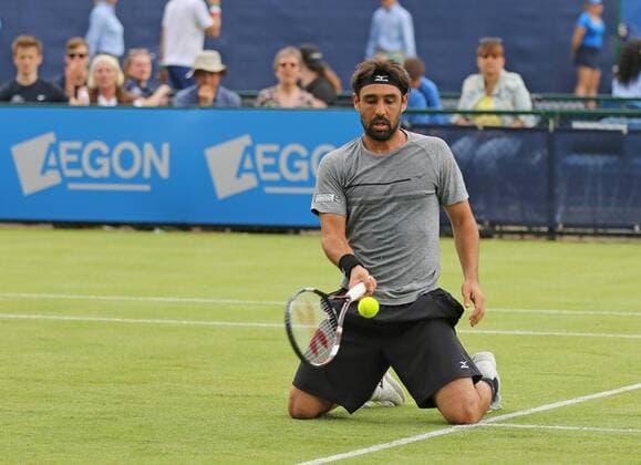 21.06.2016. Nottingham Tennis Centre, Nottingham, England. Aegon Open Mens ATP Tennis Herren Tennis. An unusual shot form Marcos Baghdatis of Cyprus after his fall as he defeats Evgeny Donskoy of Russia in two sets 7-5 and 6-2 xDavidxKissmanx  ActionPlus11752843