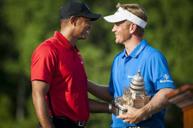 Billy Hurley III, of Annapolis, Maryland, holds the Quicken Loans National Trophy as he chats with tournament host, Tiger Woods, following the final round of the Quicken Loans National golf tournament at Congressional CC in Bethesda, Maryland on Sunday, June 36, 2016. Hurley shot a 2-under 69 on Sunday for his first tournament win.  WAP201606261066 PETExMAROVICH
