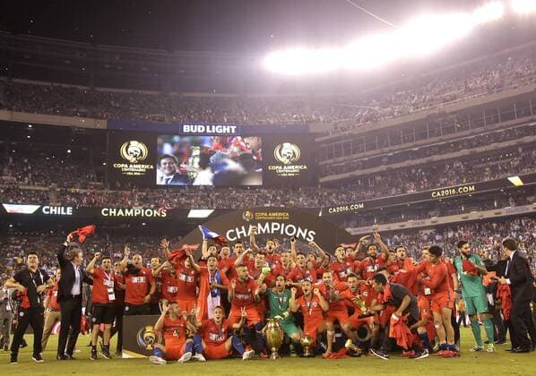 Team Chile celebrates with the champions trophy after defeating Argentina at the Copa America Centenario USA 2016 Finals at MetLife Stadium in East Rutherford, New Jersey on June 26, 2016. Chile defeated Argentina 4-2 in penalty kicks and won there second consecutive Copa America.  NYP20160626106 JOHNxANGELILLO
