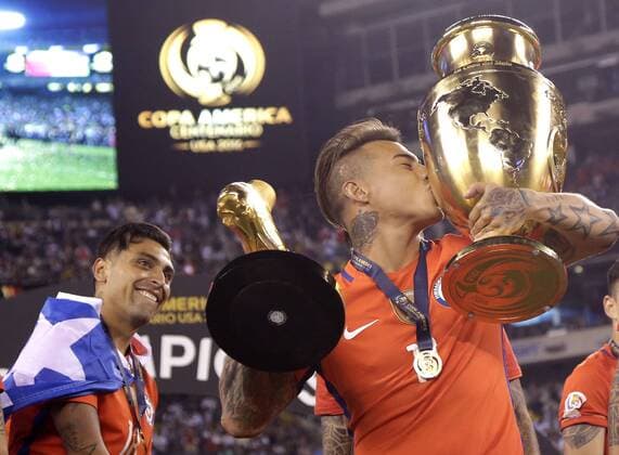 Eduardo Vargas of Chile celebrates with 2 trophies after his team defeats Argentina at the Copa America Centenario USA 2016 Finals at MetLife Stadium in East Rutherford, New Jersey on June 26, 2016. Chile defeated Argentina 4-2 in penalty kicks and won there second consecutive Copa America.  NYP20160626107 JOHNxANGELILLO