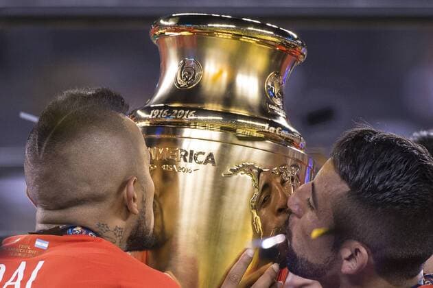 East Rutherford, New Jersey, U.S - Chile midfielder ARTURO VIDAL (8) & Chile defender MAURICIO ISLA (4) kissing the Copa America trophy after the Copa America Centenario 2016 Final at MetLife Stadium in East Rutherford, NJ Soccer 2016 - Copa America Centenario Final Chile defeats Argentina 0-0 (4-2) Penalty Shoot out. - ZUMAs192