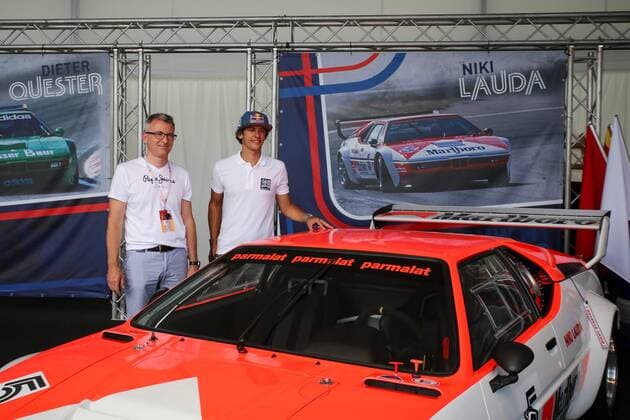 FORMULA 1 - GP of Austria 2016 SPIELBERG,AUSTRIA,30.JUN.16 - MOTORSPORTS, FORMULA 1 - Grand Prix of Austria, Red Bull Ring, preview. Image shows Patrick Friesacher (AUT) with fan and the old BMW M1 Procar car driven by Niki Lauda. GEPAxpictures xMaticxKlansek