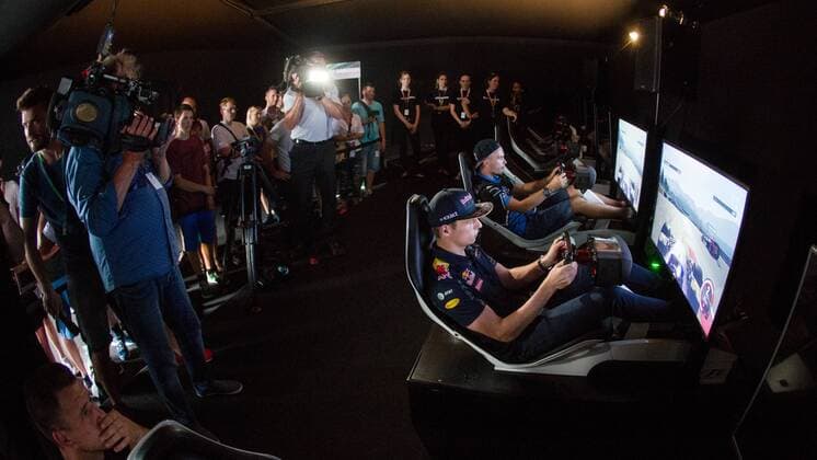 FORMULA 1 - GP of Austria 2016 SPIELBERG,AUSTRIA,30.JUN.16 - MOTORSPORTS, FORMULA 1 - Grand Prix of Austria, Red Bull Ring, preview. Image shows Max Verstappen (NED Red Bull) and Erik Lestach - hakkiJunior (SVK) playing on simulator at Gamezone. GEPAxpictures xMaticxKlansek