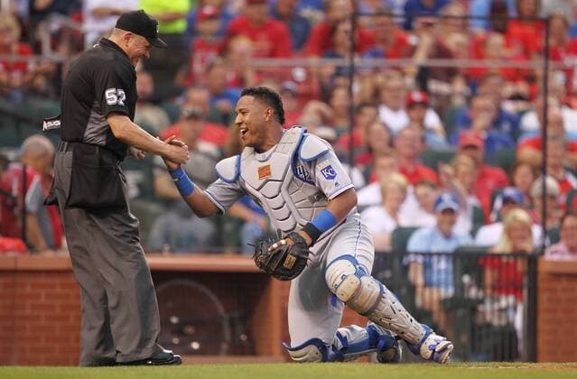 Kansas City Royals catcher Salvador Perez is helped to his feet by home plate umpire Mike Everitt after the two collided on a foul tip against the St. Louis Cardinals in the fourth inning at Busch Stadium in St. Louis on June 30, 2016.  SLP2016063006 BILLxGREENBLATT