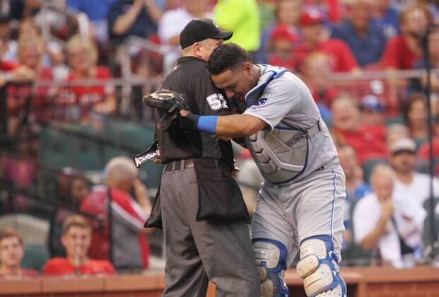 Kansas City Royals catcher Salvador Perez hugs home plate umpire Mike Everitt after the two collided on a foul tip against the St. Louis Cardinals in the fourth inning at Busch Stadium in St. Louis on June 30, 2016.  SLP2016063008 BILLxGREENBLATT