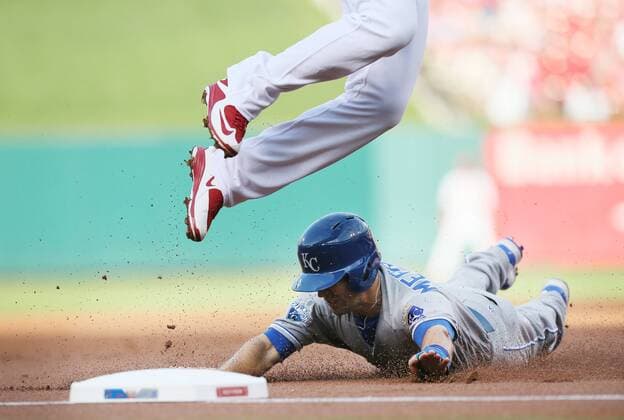 June 30, 2016 - St Louis, MO, USA - The Kansas City Royals Whit Merrifield steals third base as St. Louis Cardinals third baseman Jhonny Peralta leaps for the errant pick-off throw from catcher Brayan Pena in the first inning on Thursday, June 30, 2016, at Busch Stadium in St. Louis. Merrifield scored on the throwing error, and the Royals won, 4-2. Kansas City Royals at St. Louis Cardinals - ZUMAm67_