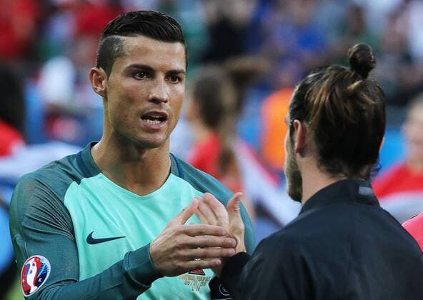 LYON, FRANCE - JULY 6, 2016: Portugal s Cristiano Ronaldo (L) and Wales Gareth Bale shake hands ahead of their 2016 UEFA European Football Championship semifinal match at Stade de Lyon. Alexander Demianchuk TASS  TS0292B9
