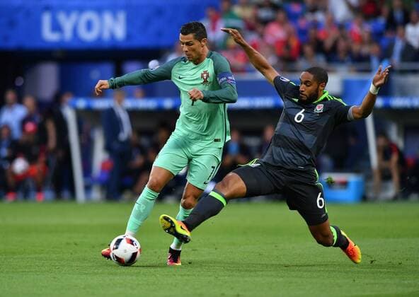 LYON, July 6, 2016 -- Cristiano Ronaldo of Portugal (L) vies with Ashley Williams of Wales during the Euro 2016 semifinal match between Portugal and Wales in Lyon, France, July 6, 2016. ) (SP)FRANCE-LYON-SOCCER-EURO 2016-SEMIFINAL-PORTUGAL VS WALES TaoxXiyi 