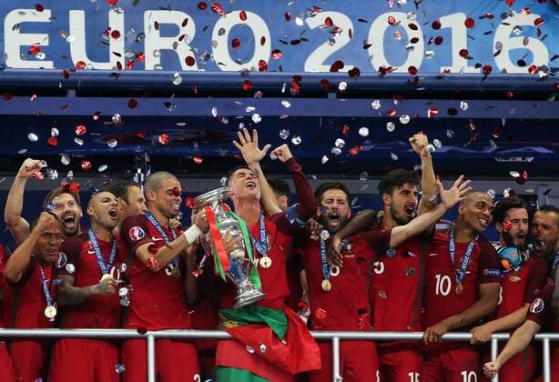 SAINT-DENIS, FRANCE - JULY 10, 2016: Portugal s Bruno Alves, Ricardo Quaresma, Pepe, Cristiano Ronaldo, Joao Mountinho, Andre Gomes, and Joao Mario (L-R front) celebrate with the trophy after winning the 2016 UEFA European Football Championship final match against France at Stade de France. Portugal won the game 1-0 and became European champions for the first time in history. Alexander Demianchuk TASS  TS029927