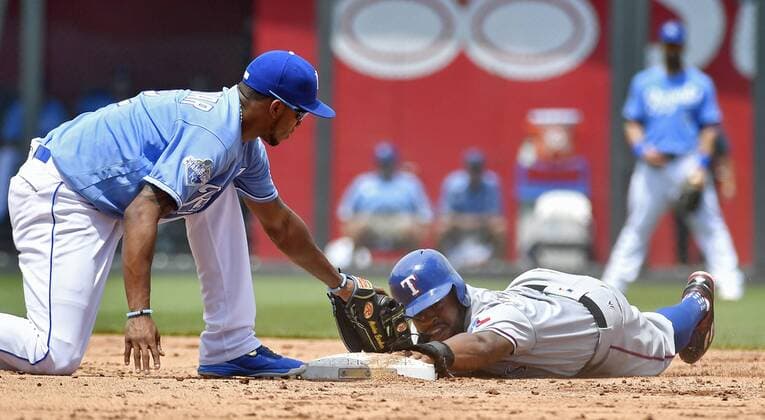 July 24, 2016 - Kansas City, MO, USA - Texas Rangers Delino DeShields steals second, sliding past the base and back on before the tag from Kansas City Royals shortstop Alcides Escobar in the third inning Sunday, July 24, 2016 at Kauffman Stadium in Kansas City, Mo. Royals fall to Rangers after Soria stumbles again - ZUMAm67_