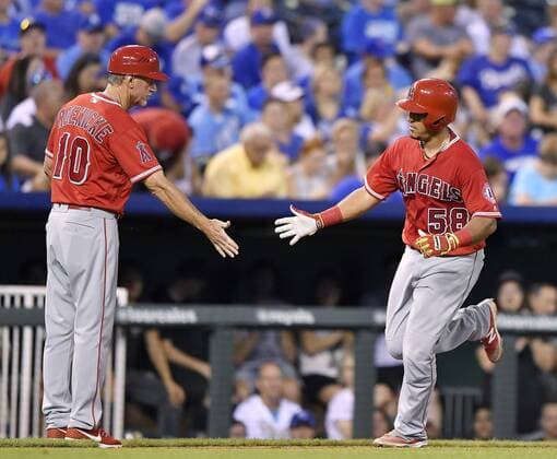 July 26, 2016 - Kansas City, MO, USA - The Los Angeles Angels Carlos Perez is congratulated by third base coach Ron Roenicke, left, after hitting a solo home run in the sixth inning against the Kansas City Royals on Tuesday, July 26, 2016, at Kauffman Stadium in Kansas City, Mo. LA Angels at Kansas City - ZUMAm67_