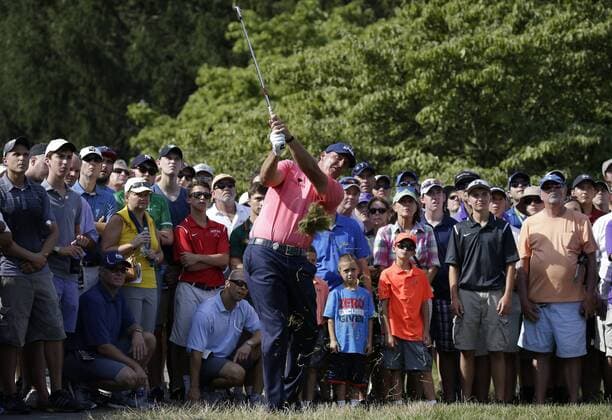 Fans watch Phil Mickelson hit out of the rough on the 14th hole in the first round at the PGA Golf Herren Championship at Baltusrol Golf Club in Springfield, New Jersey on July 28, 2016.  PGA20160728115 JOHNxANGELILLO
