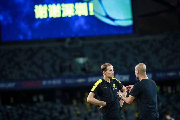 Head coach Pep Guardiola of Manchester City, right, talks to head coach Thomas Tuchel of Borussia Dortmund before the penalty shootout of the Shenzhen match of the 2016 International Champions Cup China in Shenzhen city, south China s Guangdong province, 28 July 2016. Pep Guardiola got his first taste of victory as Manchester City s manager Thursday (28 July 2016) night after beating Borussia Dortmund on penalties in a friendly, but expressed concern about the looming English Premier League season. Football today is tough, said Guardiola, whose side beat their German opposition in the southern Chinese city of Shenzhen. City won, and finally got the workout Guardiola had craved, thanks to a 6-5 penalty shootout win over Dortmund, after the game ended one apiece. City keeper Angus Gunn was the hero of penalties with three saves, including the one sealing their victory when he palmed away Mikel Merino s attempt. Manchester City beat Dortmund on penalties in Shenzhen  20160728_12256
