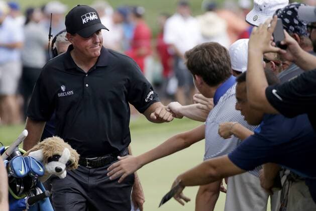 Phil Mickelson bumps fists with fans as he arrives on the 4th tee box in the second round at the PGA Golf Herren Championship at Baltusrol Golf Club in Springfield, New Jersey on July 29, 2016.  PGA20160729119 JOHNxANGELILLO