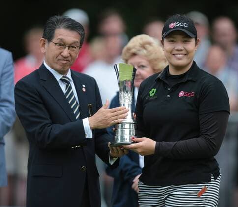 July 31, 2016 - Woburn, United Kingdom - Ariya Jutanugarn of Thailand receives the trophy from Jake Yamashita of Ricoh following her victory during The Ricoh Women s British Open played at Woburn Golf and Country Club, Woburn on July 31st 2016. Ricoh Women s British Open 2016 Day Four  - ZUMAn230