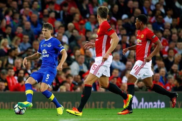 03.08.2016. Old Trafford, Manchester, England. Wayne Rooney Testimonial Football Match. Manchester United ManU versus Everton. John Stones of Everton crosses as he is closed down by by Michael Carrick of Manchester United and Anthony Martial of Manchester United xPaulxKeevilx  ActionPlus11767568