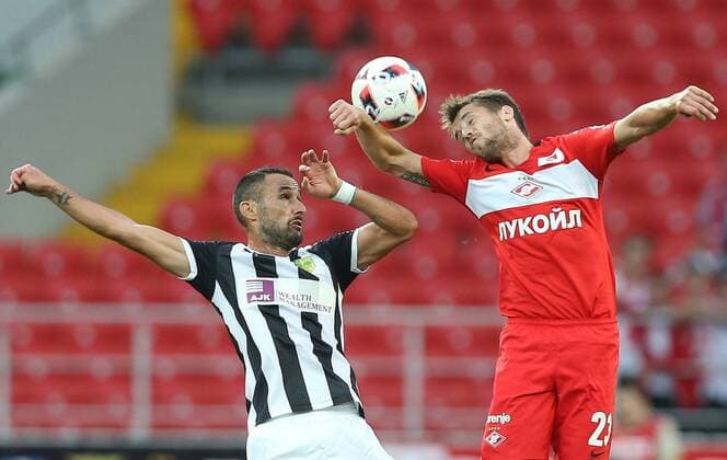 MOSCOW, RUSSIA - AUGUST 4, 2016: AEK Larnaka s Juanma Ortiz (17, left), and Spartak Moscow s Dmitry Kombarov (23) jump to head the ball in their 2016 2017 UEFA Europa League Third Qualifying Round football match at Otkrytie Arena. Artyom Korotayev TASS  TS02BD13