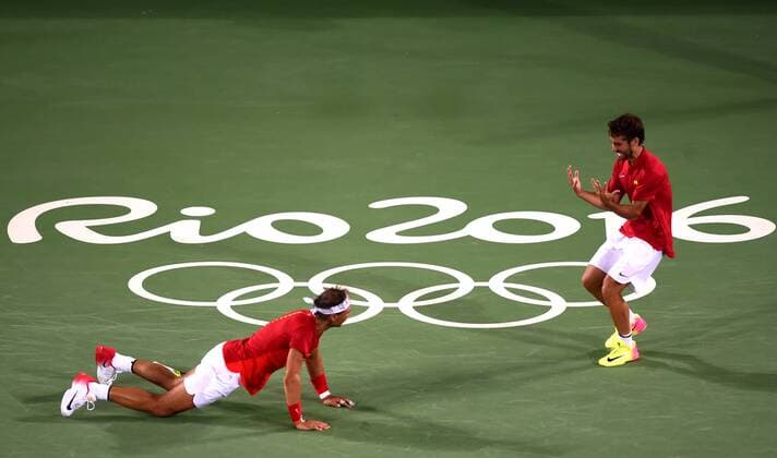 (160812) -- RIO DE JANEIRO, Aug. 12, 2016 -- Rafael Nadal (L) and Marc Lopez of Spain celebrate after the final of men s doubles tennis against Florin Mergea and Horia Tecau of Romania at the 2016 Rio Olympic Games Olympische Spiele Olympia OS in Rio de Janeiro, Brazil, on Aug. 12, 2016. Rafael Nadal and Marc Lopez won the gold medal. )(dh) (SP)BRAZIL-RIO DE JANEIRO-OLYMPICS-TENNIS YuexYuewei 