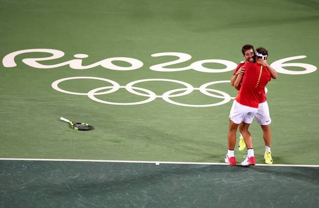 (160812) -- RIO DE JANEIRO, Aug. 12, 2016 -- Rafael Nadal (front) and Marc Lopez of Spain celebrate after the final of men s doubles tennis against Florin Mergea and Horia Tecau of Romania at the 2016 Rio Olympic Games Olympische Spiele Olympia OS in Rio de Janeiro, Brazil, on Aug. 12, 2016. Rafael Nadal and Marc Lopez won the gold medal. )(dh) (SP)BRAZIL-RIO DE JANEIRO-OLYMPICS-TENNIS YuexYuewei 
