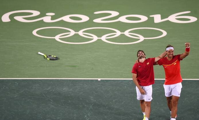 (160812) -- RIO DE JANEIRO, Aug. 12, 2016 -- Rafael Nadal (R) and Marc Lopez of Spain celebrate after the final of men s doubles tennis against Florin Mergea and Horia Tecau of Romania at the 2016 Rio Olympic Games Olympische Spiele Olympia OS in Rio de Janeiro, Brazil, on Aug. 12, 2016. Rafael Nadal and Marc Lopez won the gold medal. )(dh) (SP)BRAZIL-RIO DE JANEIRO-OLYMPICS-TENNIS YuexYuewei 