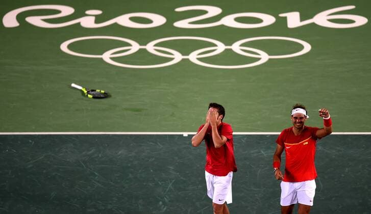 (160812) -- RIO DE JANEIRO, Aug. 12, 2016 -- Rafael Nadal (R) and Marc Lopez of Spain celebrate after the final of men s doubles tennis against Florin Mergea and Horia Tecau of Romania at the 2016 Rio Olympic Games Olympische Spiele Olympia OS in Rio de Janeiro, Brazil, on Aug. 12, 2016. Rafael Nadal and Marc Lopez won the gold medal. )(dh) (SP)BRAZIL-RIO DE JANEIRO-OLYMPICS-TENNIS YuexYuewei 