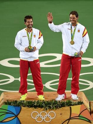 (160812) -- RIO DE JANEIRO, Aug. 12, 2016 -- Rafael Nadal (R) and Marc Lopez of Spain celebrate at the awarding ceremony of men s doubles tennis at the 2016 Rio Olympic Games Olympische Spiele Olympia OS in Rio de Janeiro, Brazil, on Aug. 12, 2016. Rafael Nadal and Marc Lopez won the gold medal. )(dh) (SP)BRAZIL-RIO DE JANEIRO-OLYMPICS-TENNIS YuexYuewei 