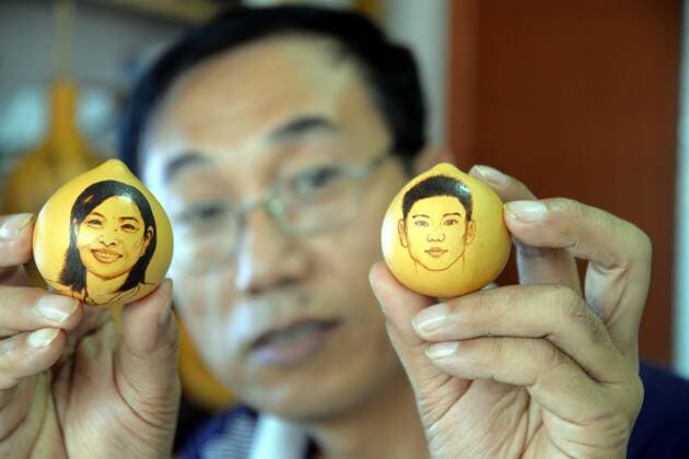 Liaocheng, Liaocheng, China - Liaocheng Portraits of Olympic Gold Medalists on the surface of egg-shaped gourds made by Chinese folk artist Ji Zhenshan.Ji Zhenshan, a folk artist living in east China s Shandong Province, paints portraits of Olympic gold medalists on the surface of egg-shaped gourds celebrating Chinese athletes achievements at the on-going 2016 Rio Olympic Games Olympische Spiele Olympia OS Ji has painted the portraits of Chinese champions including swimmer Sun Yang, diver Wu Minxia and pistol shooter Zhang Mengxue. Now he still continues painting more electric ironing portraits of Chinese gold medalists on the surface of egg-shaped gourds. Chinese Folk Artist Paints Portraits of Olympic Champions on Guard  - ZUMAs145