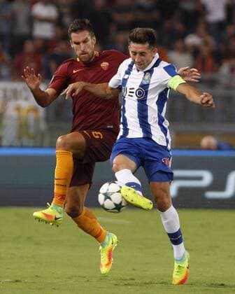 Italy: Soccer Champions League: Porto defeats Roma RomaÕs Kevin Strootman, left, and FC PortoÕs Hector Herrera fight for the ball during the Champions League play-offs second leg soccer match between Roma and FC Porto at the Olympic stadium. Porto won 3-0 to join the tournament group stage.  RiccardoxDexLucax xPacificxPress