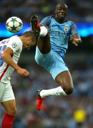 Yaya Toure of Manchester City competes for a high aerial ball with Marko Momcilovic of FC Steaua Bucuresti during the Champions League Play Off 2nd Leg match at the Etihad Stadium, Manchester. Picture date: August 24th, 2016. Pic Simon Bellis Sportimage EDITORIAL USE ONLY. No use with unauthorised audio, video, data, fixture lists, club league logos or live services. Online in-match use limited to 120 images, no video emulation. No use in betting, games or single club league player publications.