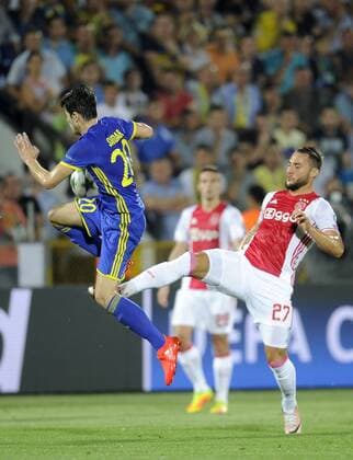 ROSTOV-ON-DON, RUSSIA - AUGUST 24, 2016: Rostov s Sardar Azmoun (L) and Ajax s Nemanja Gudelj fight for the ball in their 2016 17 UEFA Champions League First playoff round 2nd leg match at Olimp-2 Stadium. FC Rostov won the game 4:1. Valery Matytsin TASS  TS02E7ED