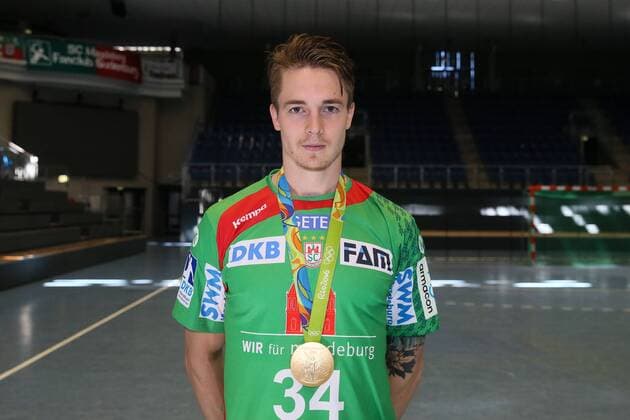 Handball, 1. BL, SC Magdeburg Porträttermin Michael Damgaard (SC Magdeburg) mit seiner olympischen Goldmedaille von Rio - Handball Bundesliga Saison 2016-2017 Offizeller Fototermin SC Magdeburg in der GETEC Arena in Magdeburg - Einzelbild,Portrait,Deutschland, Handball, Mann, Maenner,25.08.2016