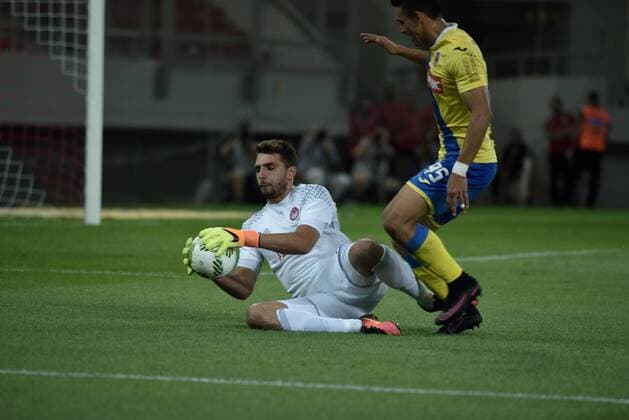 Greece: UEFA Europa League First playoff round, Game 2 Stefanos Kapino (no 27) goalkeeper of Olympiacos, catch the ball in front of Walter Gonzalez of Arouca (no 95) Final score, Olympiacos got 2 points while the Arouca got 1 point.  DimitriosxKarvountzisx xPacificxPress