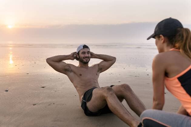 Athletes couple training on the beach at sunset model released Symbolfoto  MGOF002151
