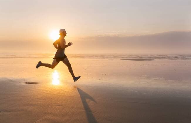 Man running on the beach at sunset model released Symbolfoto  MGOF002143